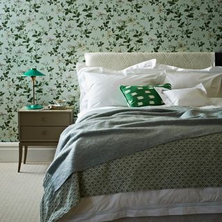 Green and white bed with green beside table and wall