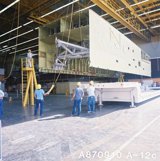 The mid-fuselage is being delivered from General Dynamics (San Diego) to the Rockwell Palmdale facility on September 10, 1987.