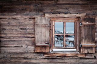 A brown cabin and window