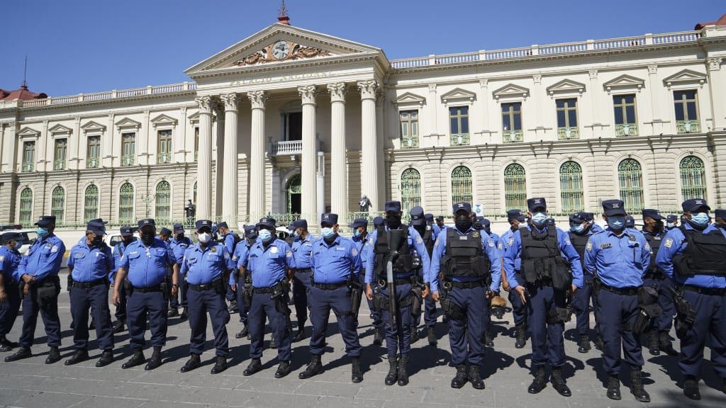 Police stand at alert in San Salvador.