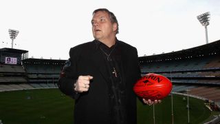 Meat Loaf with a rugby ball at the Melbourne Cricket Ground