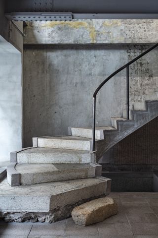 raw concrete staircase in Nekoyacho Bldg by Suppose Design Office