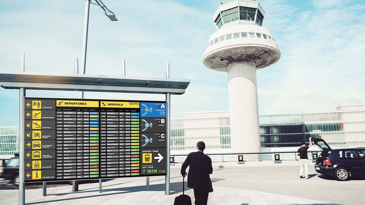 A Planar outdoor LED video wall showing arrival and departure times at an airport.