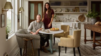 Chris Loves Julia posing in the dining area of a kitchen