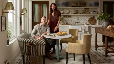 Chris Loves Julia posing in the dining area of a kitchen