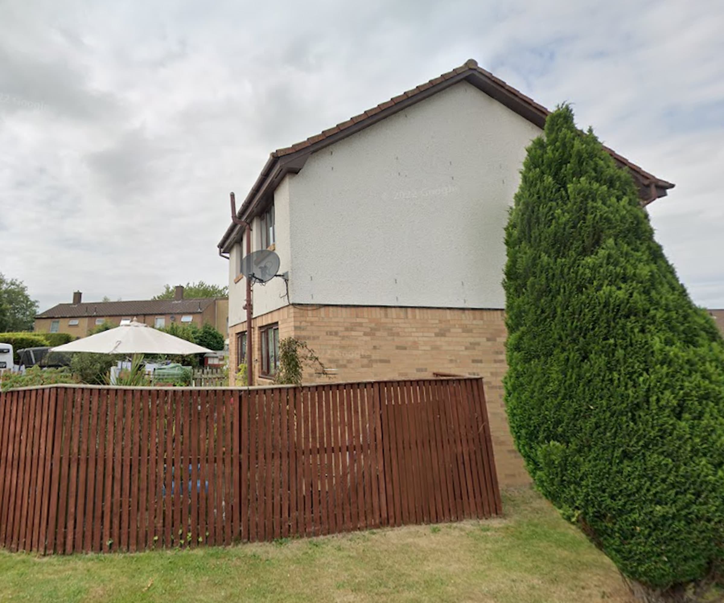 A side-on view of a back garden fence for a two-storey home