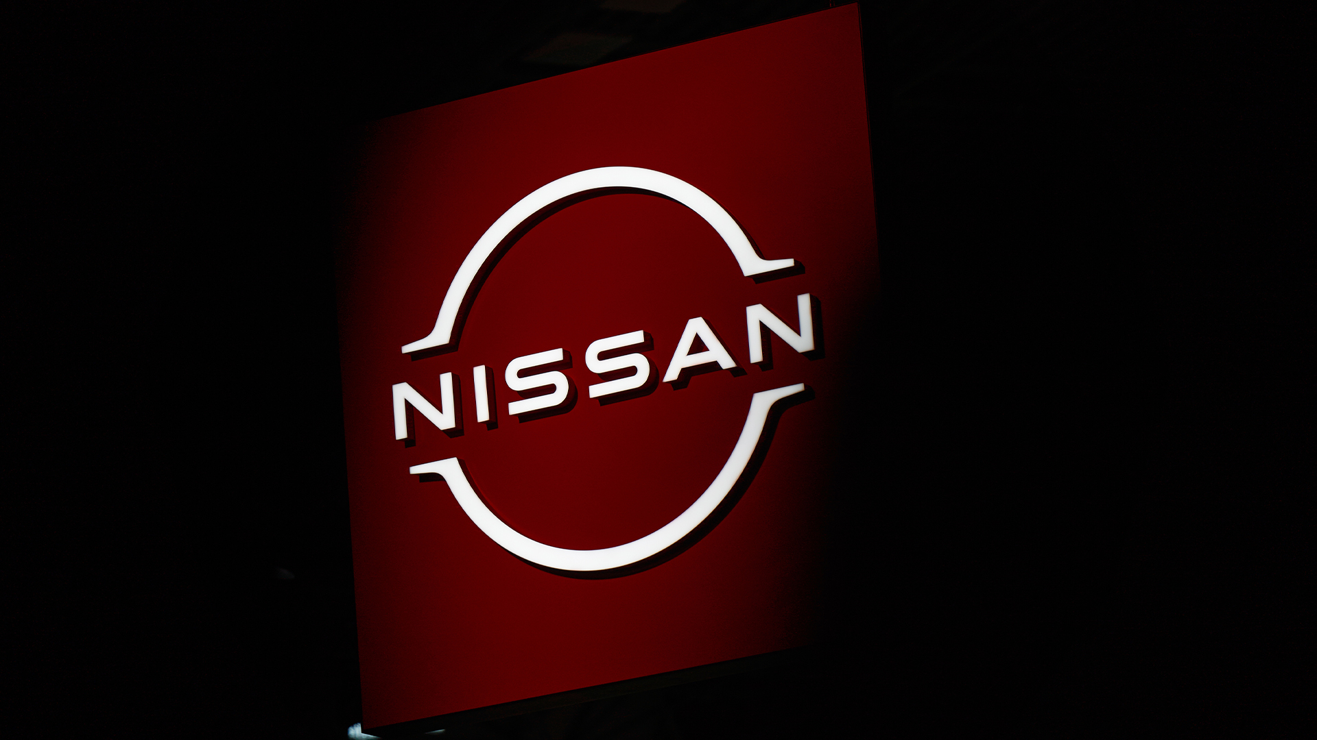 Nissan logo and branding illuminated against a dark backdrop at the 2026 New York International Auto Show in New York City, USA.