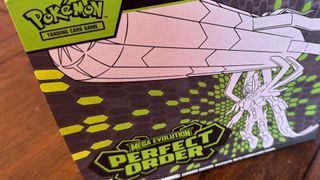 Pokemon TCG Perfect Order Elite Trainer Box on a wooden table