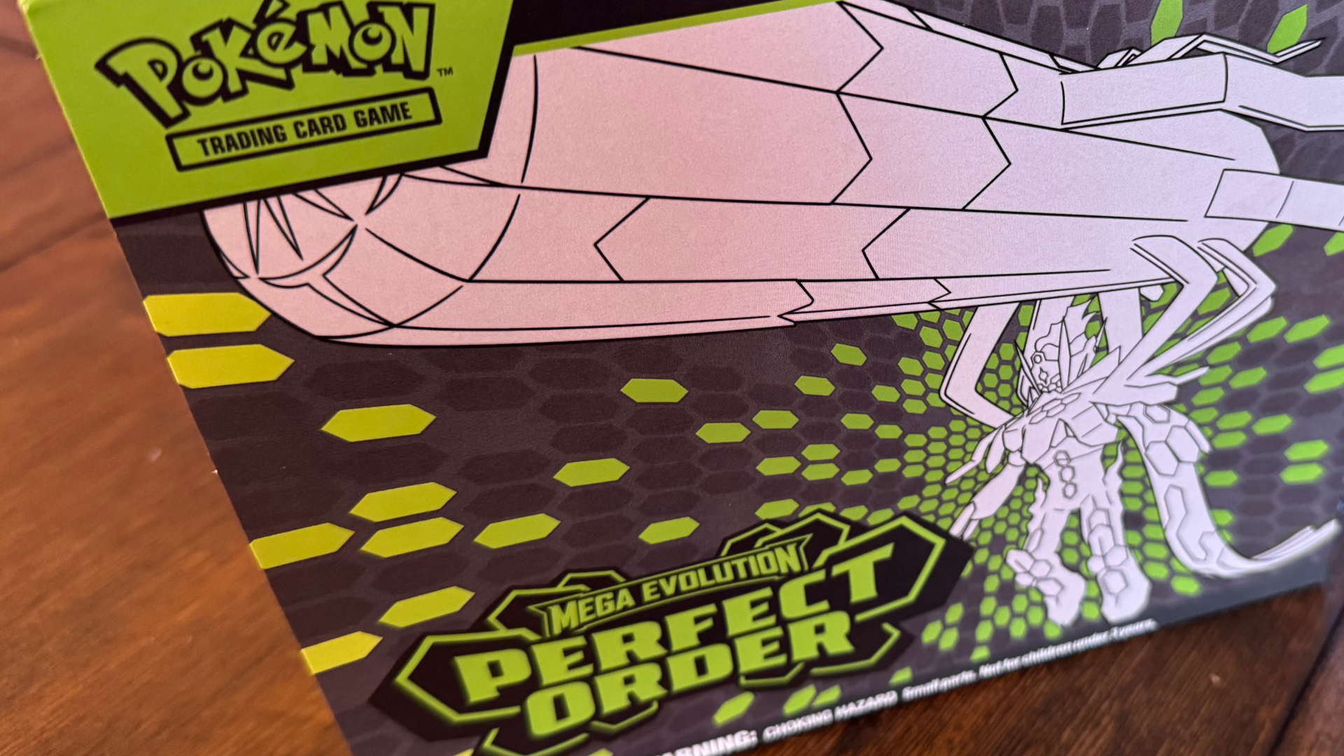 Pokemon TCG Perfect Order Elite Trainer Box on a wooden table
