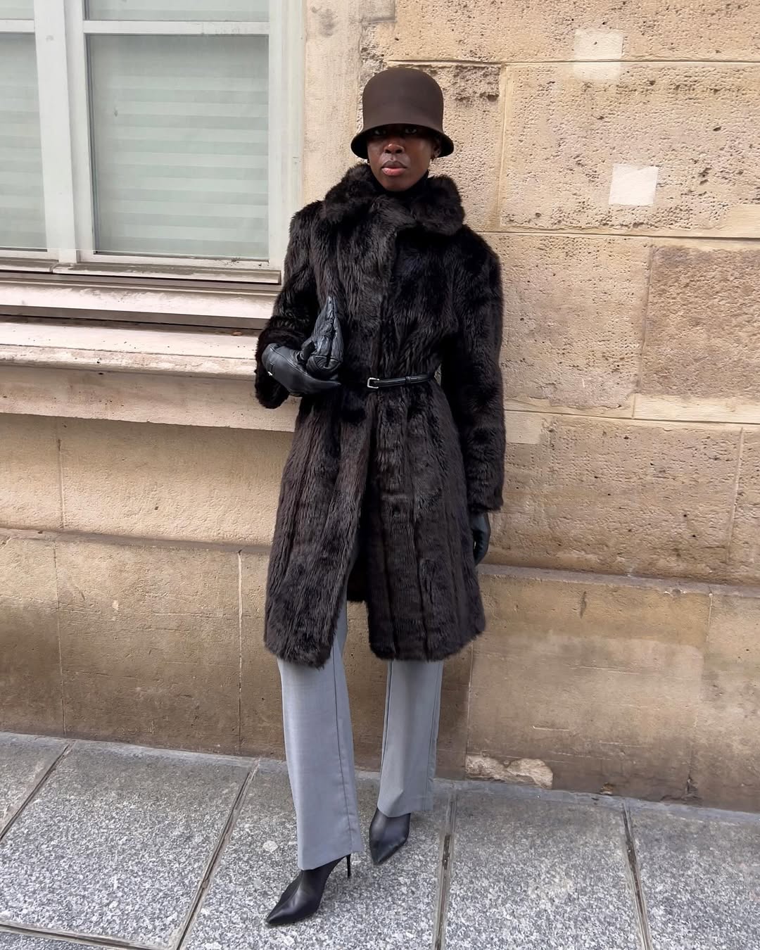 French woman wearing brown fur coat and St. Agni gray trousers.