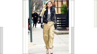 Gigi Hadid wears a silver top and matching heels with cream cargo trousers as she is seen on the set of a photo shoot for Maybelline on January 17, 2023 in New York City.