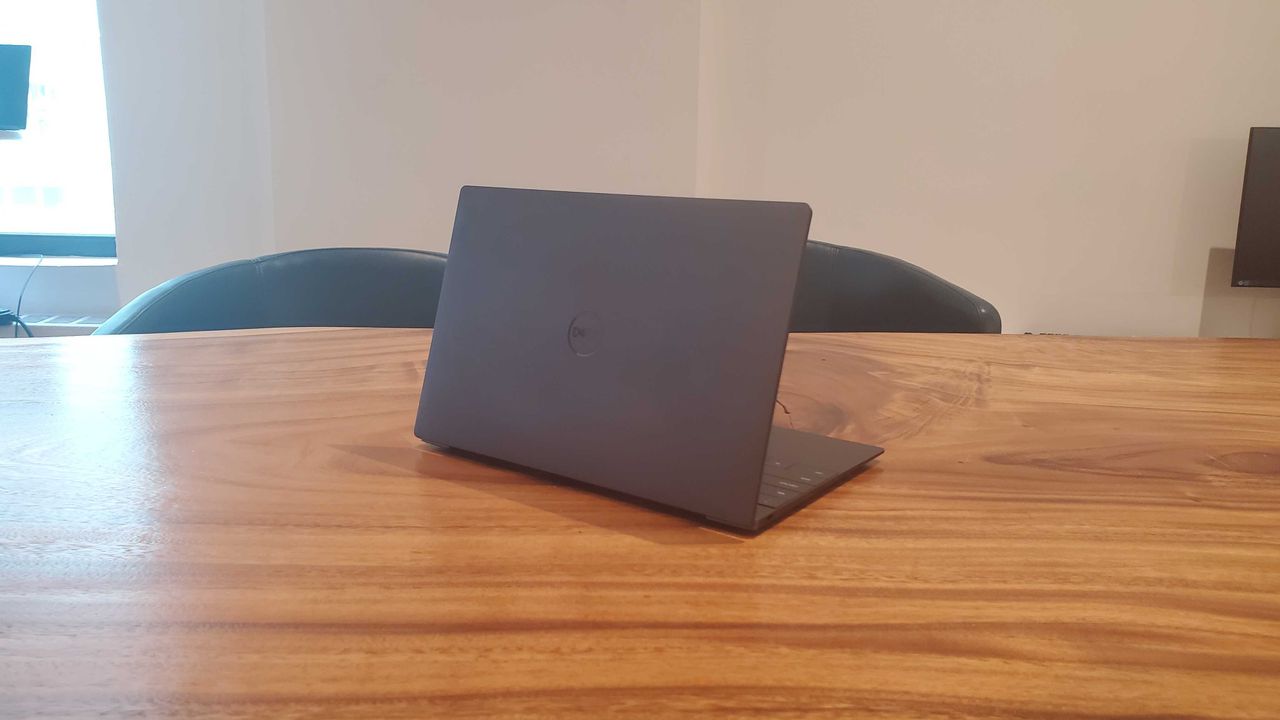 black gaming laptop on wooden table