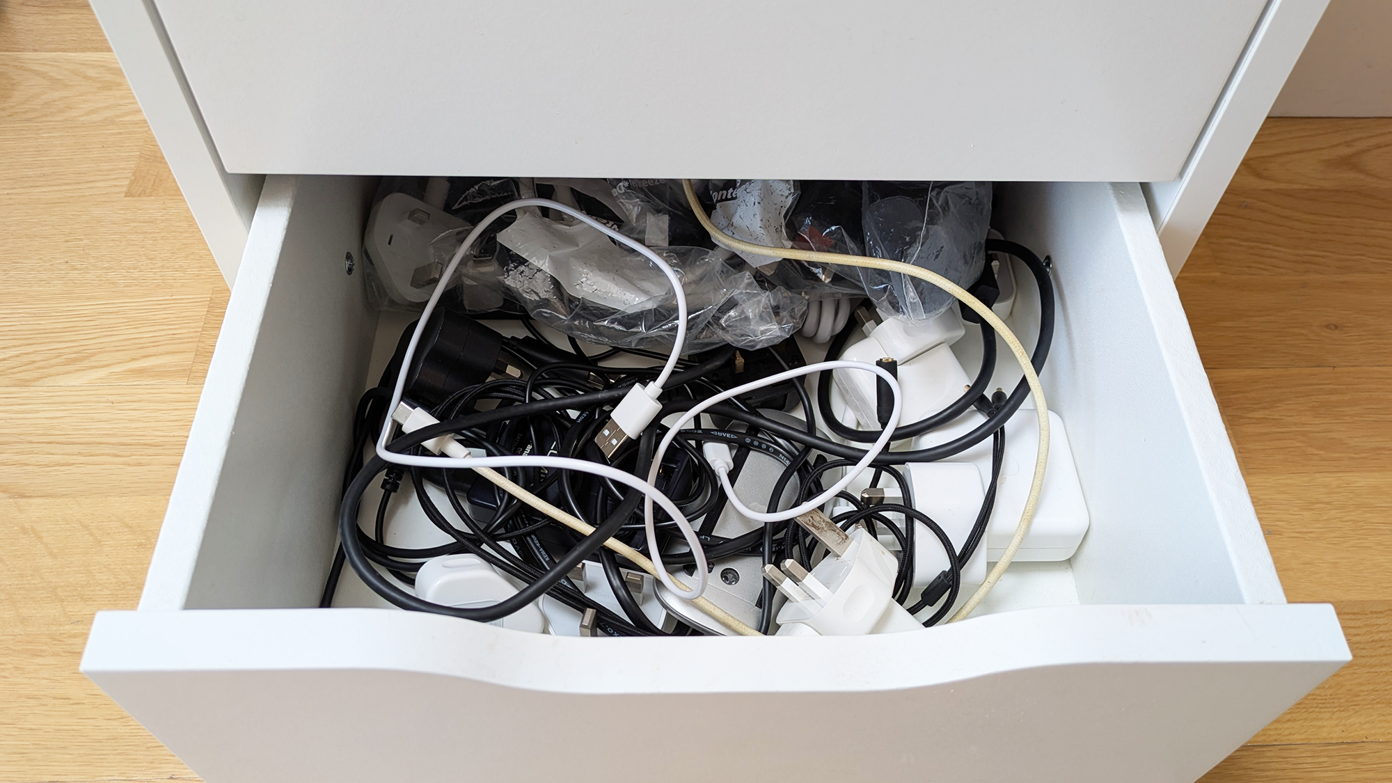 Messy drawer full of cables