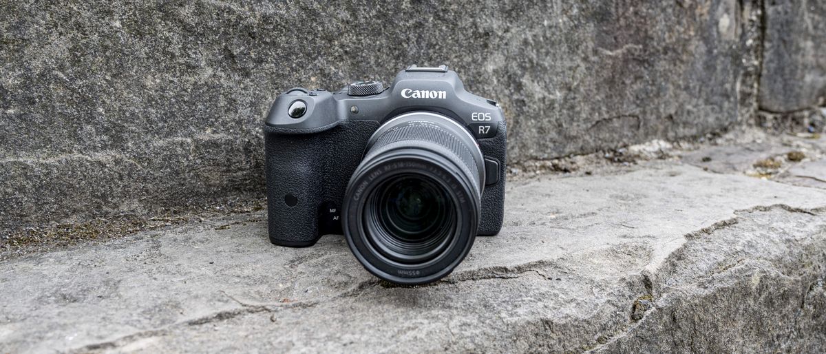 The Canon EOS R7 camera sitting on a stone step