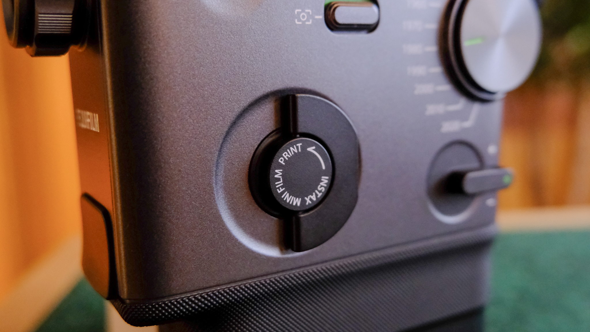 A black Fujifilm Instax mini Evo Cinema hybrid instant camera