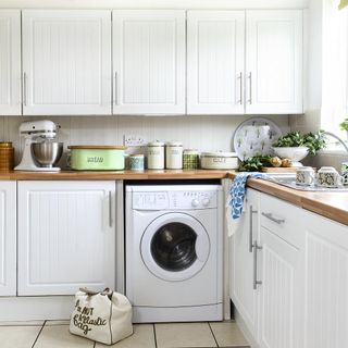 kitchen with white cabinets with white washing machine