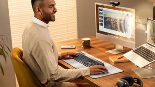Logitech Signature Slim Solar+ K980 being used by a person at a desk