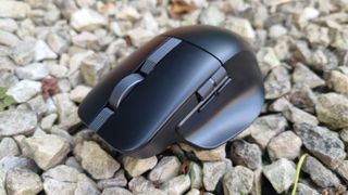 An Asus ProArt Mouse MD310 on white gravel