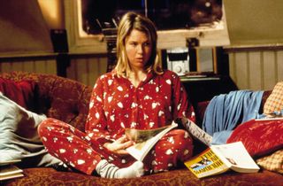 renee zellwegger wears pajamas and sits on a couch in Bridget Jones's Diary