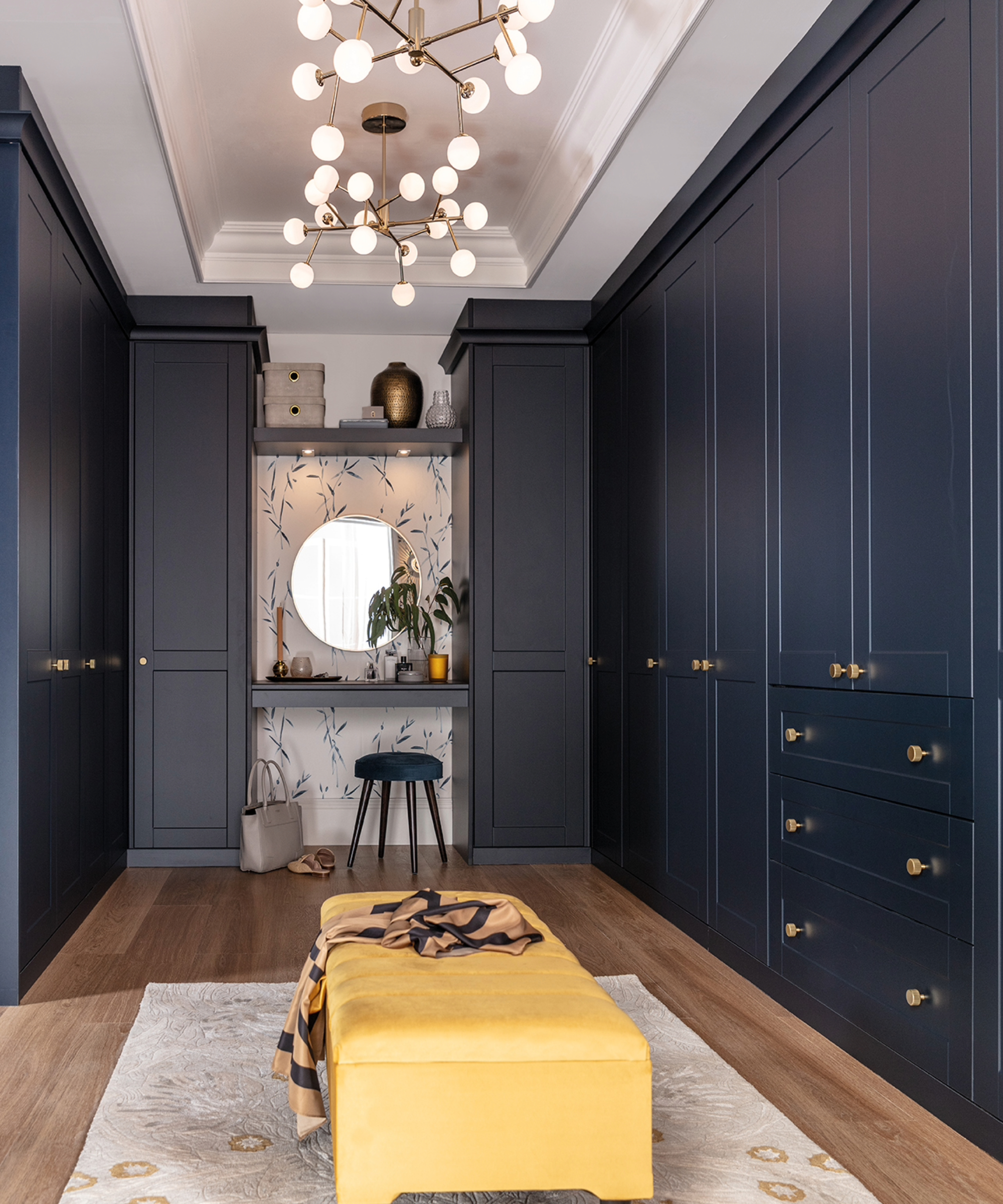 Sharps Shaker Dressing Room In Midnight Blue with a mustard stool in the center and statement lighting