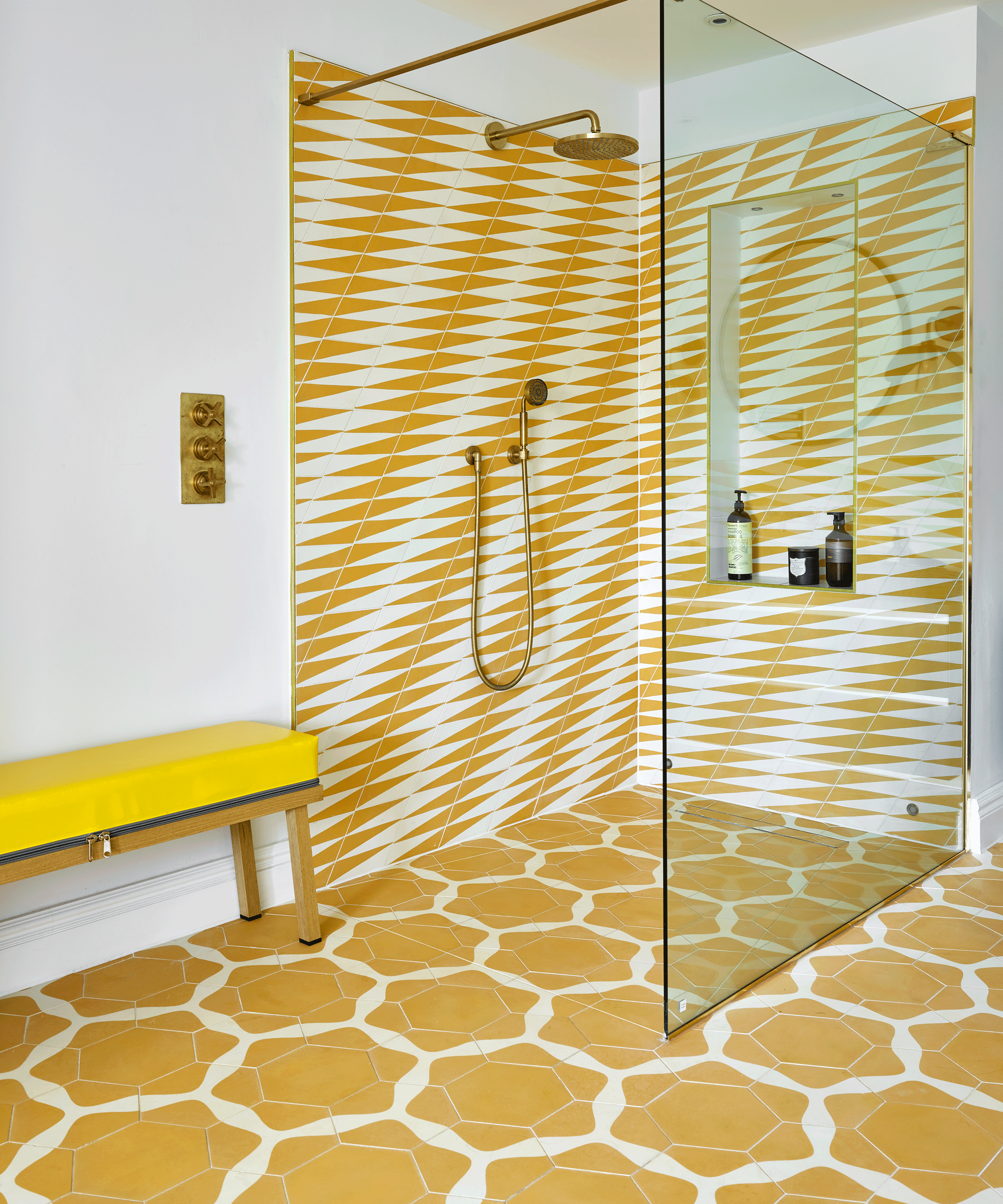 Clashing yellow pattern tiles in shower