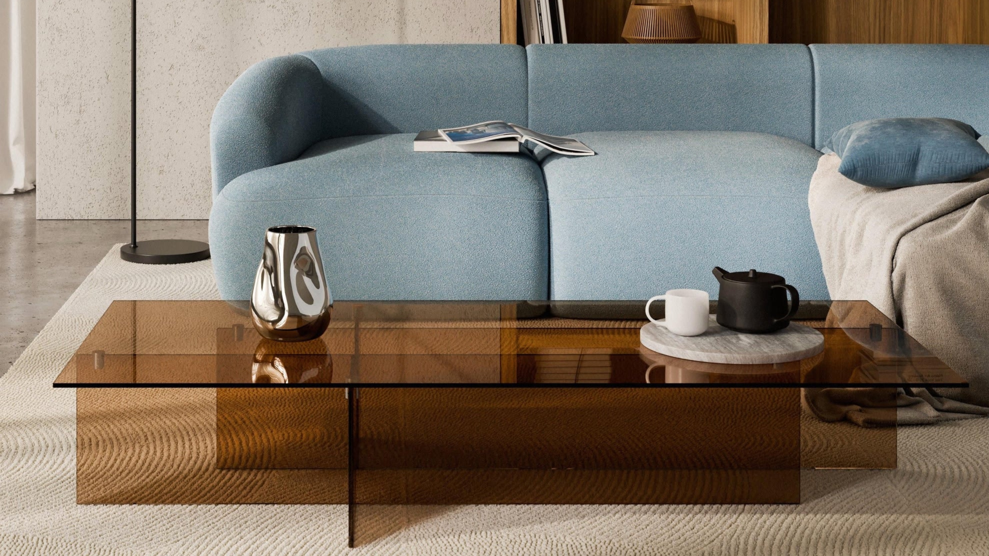 a transparent coffee table with a blue sofa in a modern room