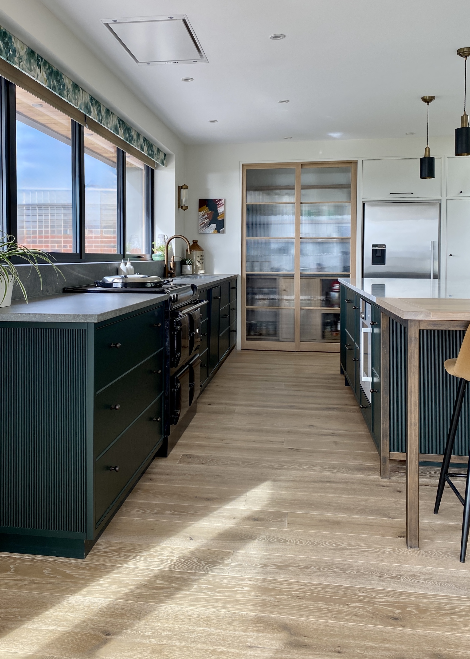 green kitchen with wood floors