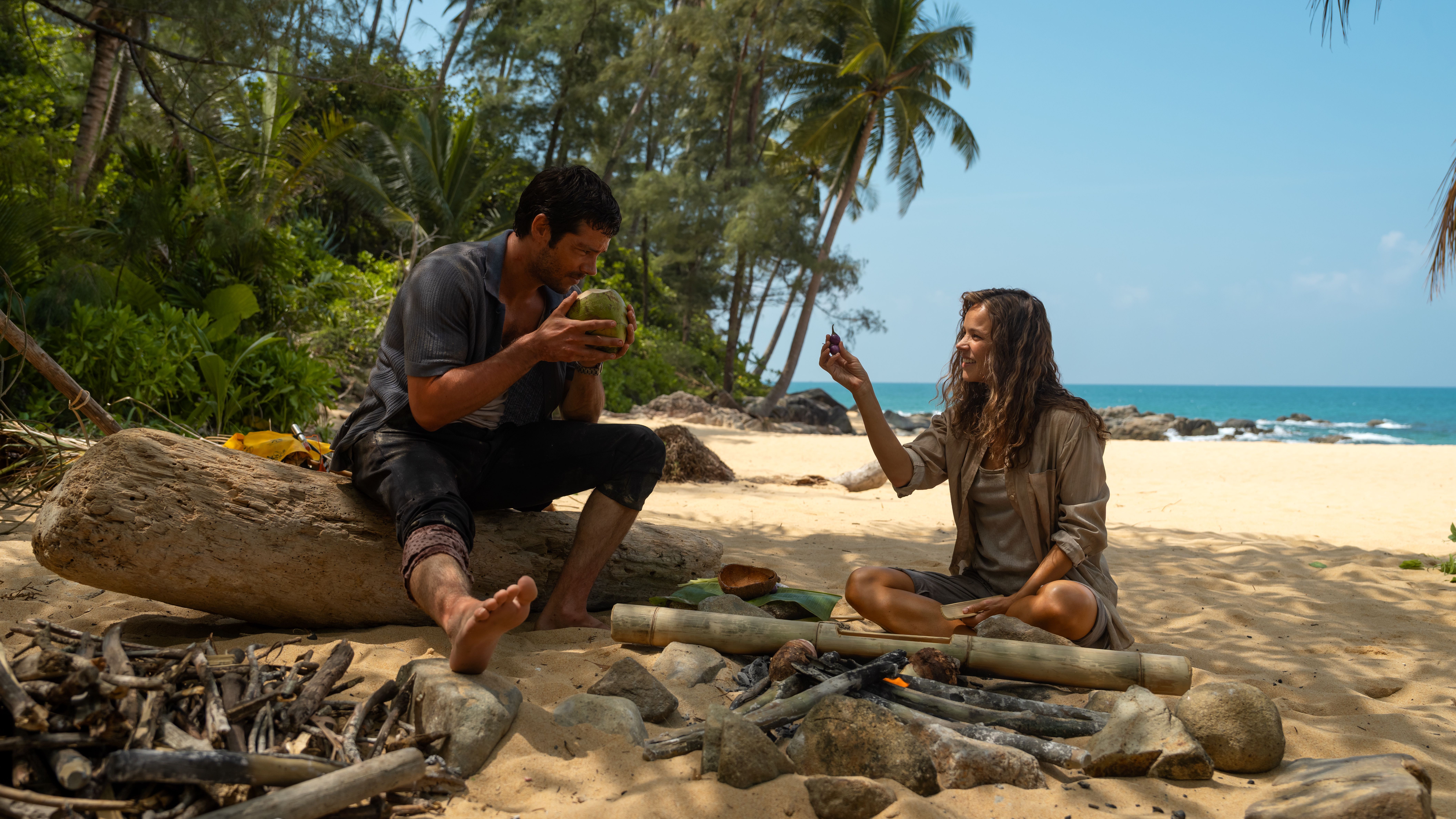 L-R: Bradley (Dylan O'brien) and Linda (Rachel McAdams) sitting by a campfire in a scene from &amp;quot;Send Help&amp;quot;