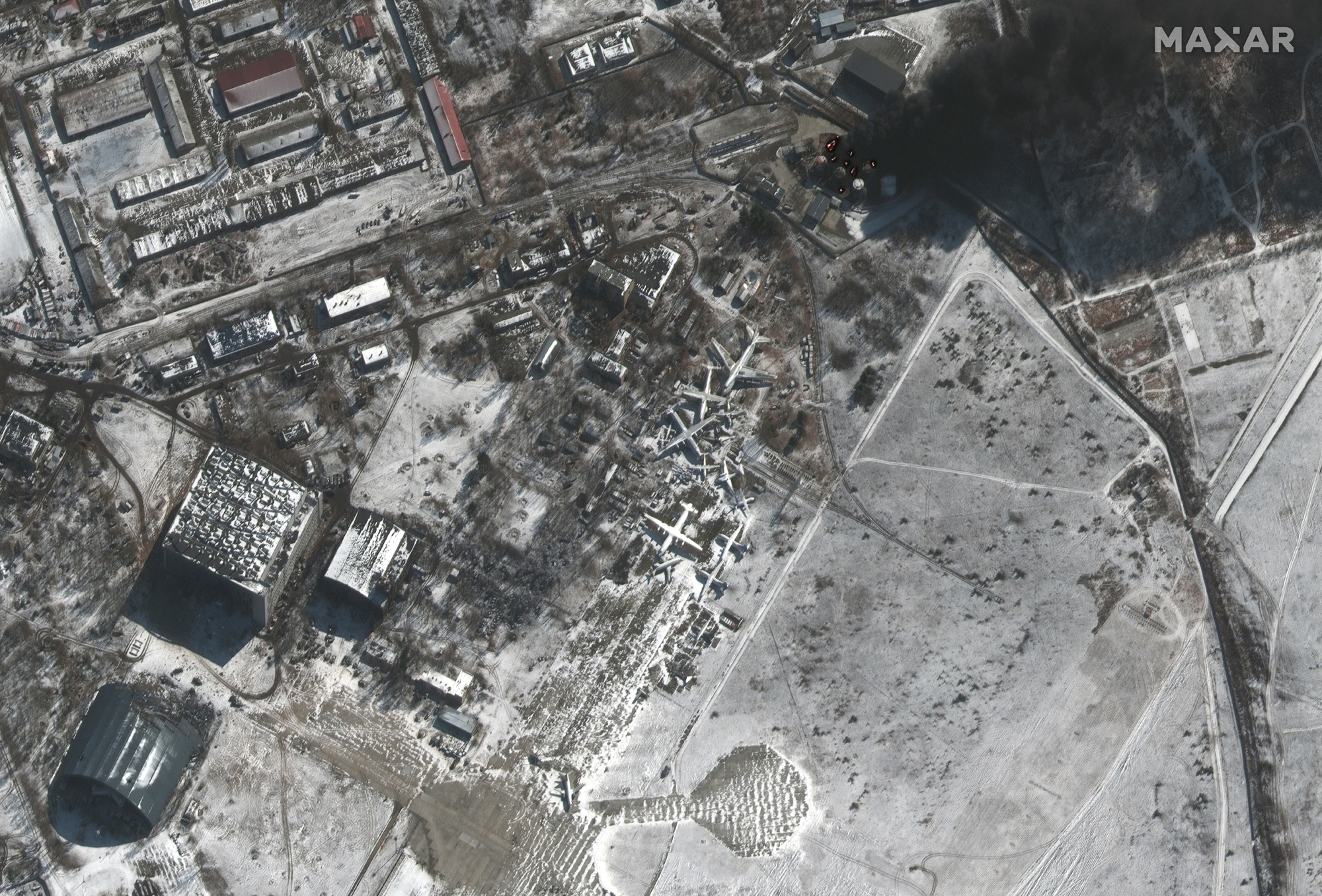 This Maxar satellite image shows uel storage tanks on fire and military equipment deployed around Antonov Airport near Kyiv, Ukraine on March 10, 2022.