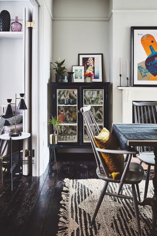 dining room with a black glass fronted cabinet in an alcove