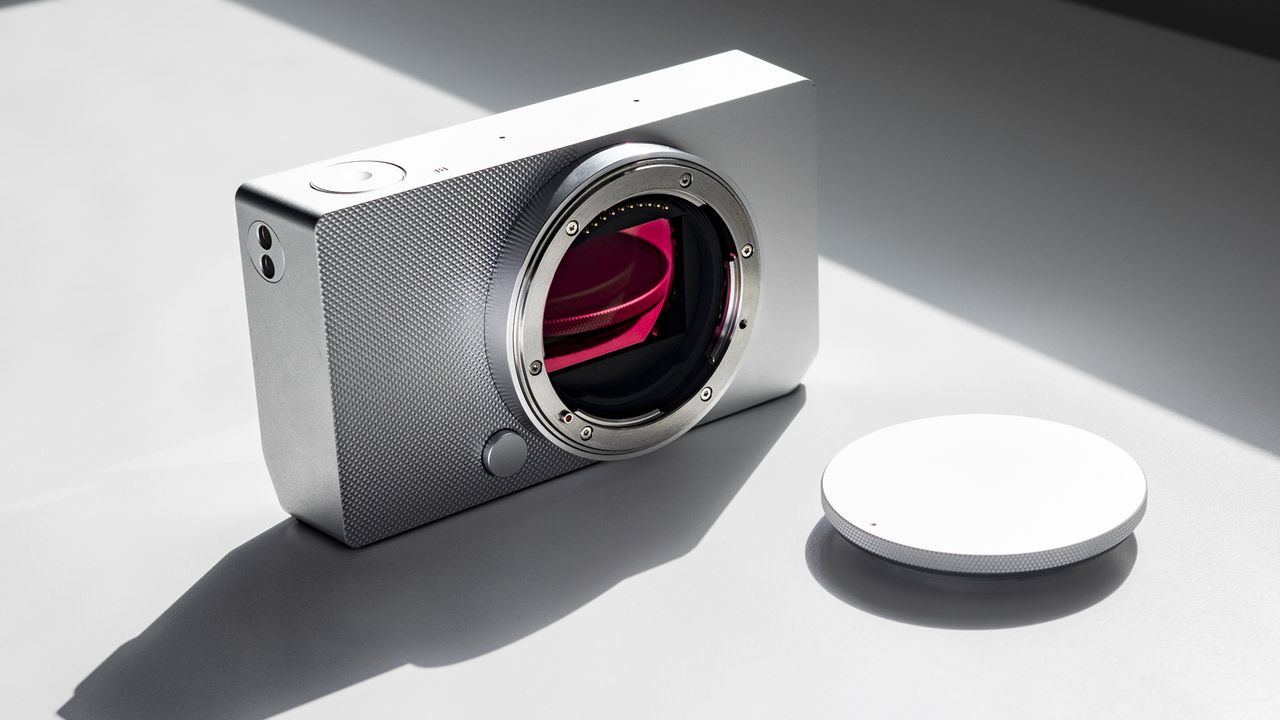 Sigma BF with its body cap, on a white surface in strong light, with defined shadows