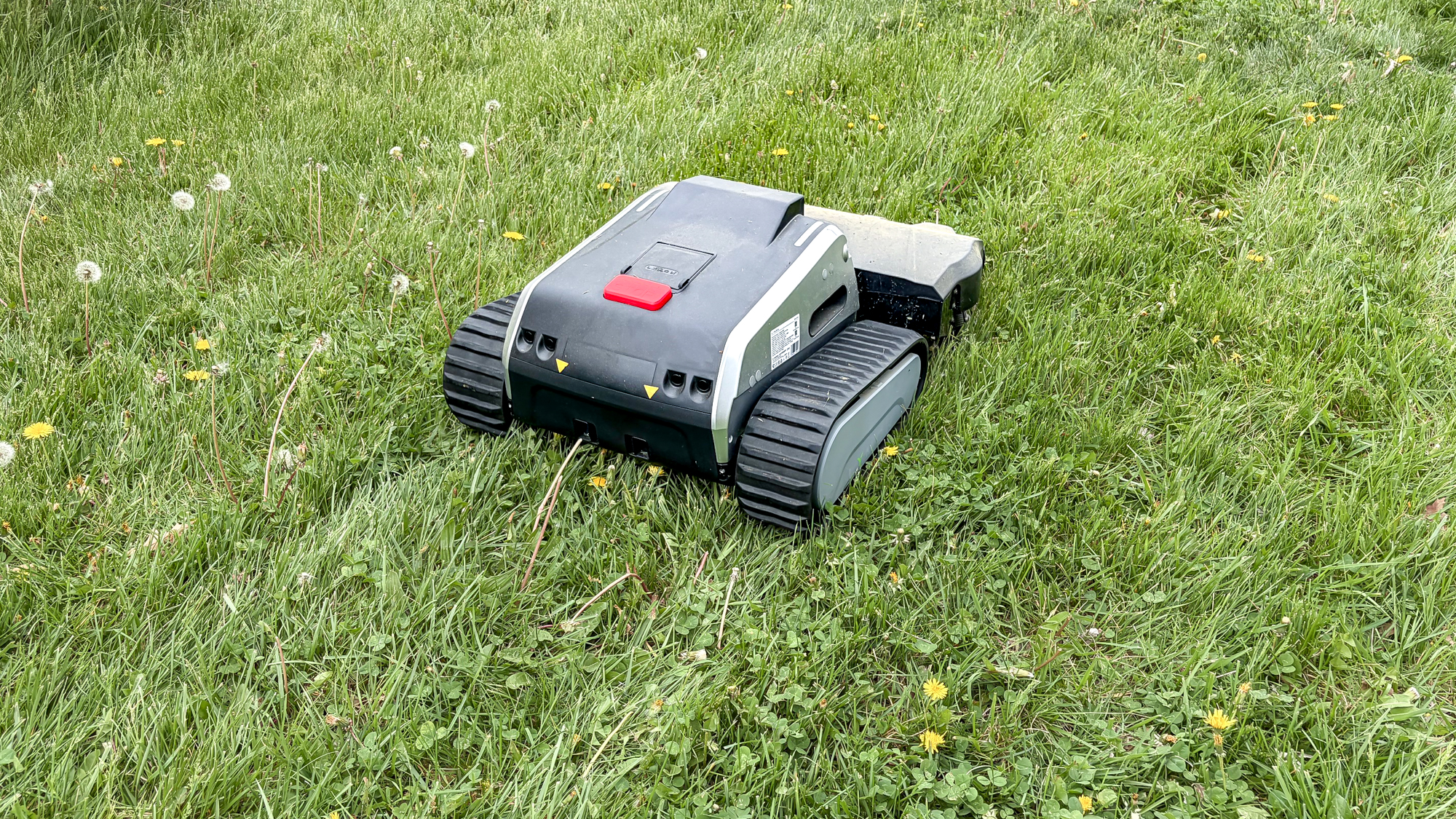 Lymow One Plus robot mower on a lawn