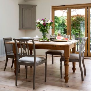 dining area with wooden floor flower pot on dining table