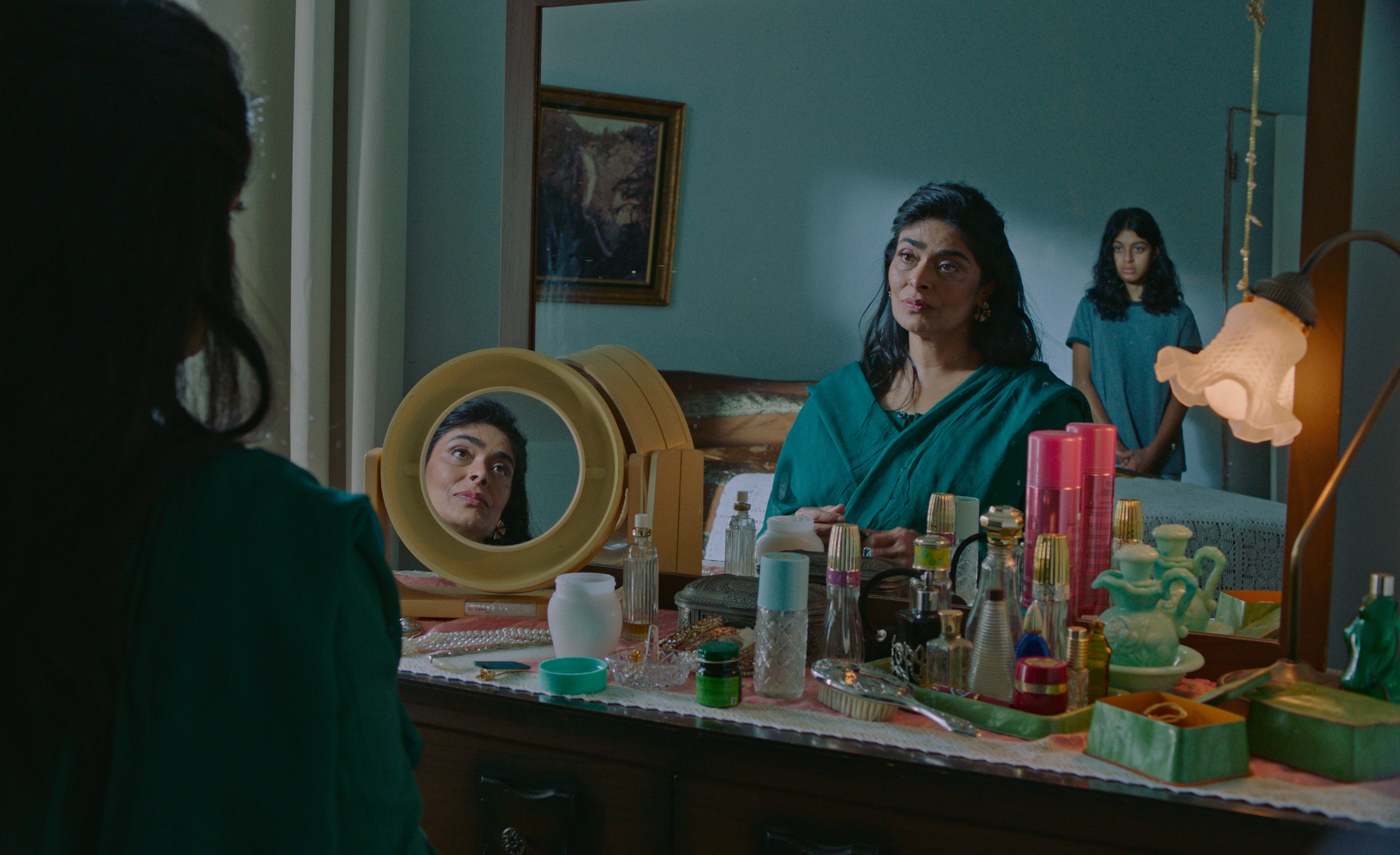 Nimra Bucha as Mariam and Ayana Manji as Young Azra talking to each other and looking in a mirror in the movie the queen of my dreams