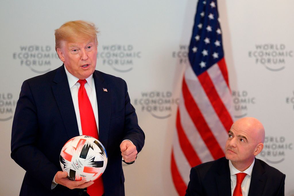 US President Donald Trump (L) holds a football as he speaks with FIFA President Gianni Infantino during the Global Chief Executive Officers dinner at the World Economic Forum in Davos, Switzerland, on January 21, 2020. (Photo by JIM WATSON / AFP) (Photo by JIM WATSON/AFP via Getty Images)