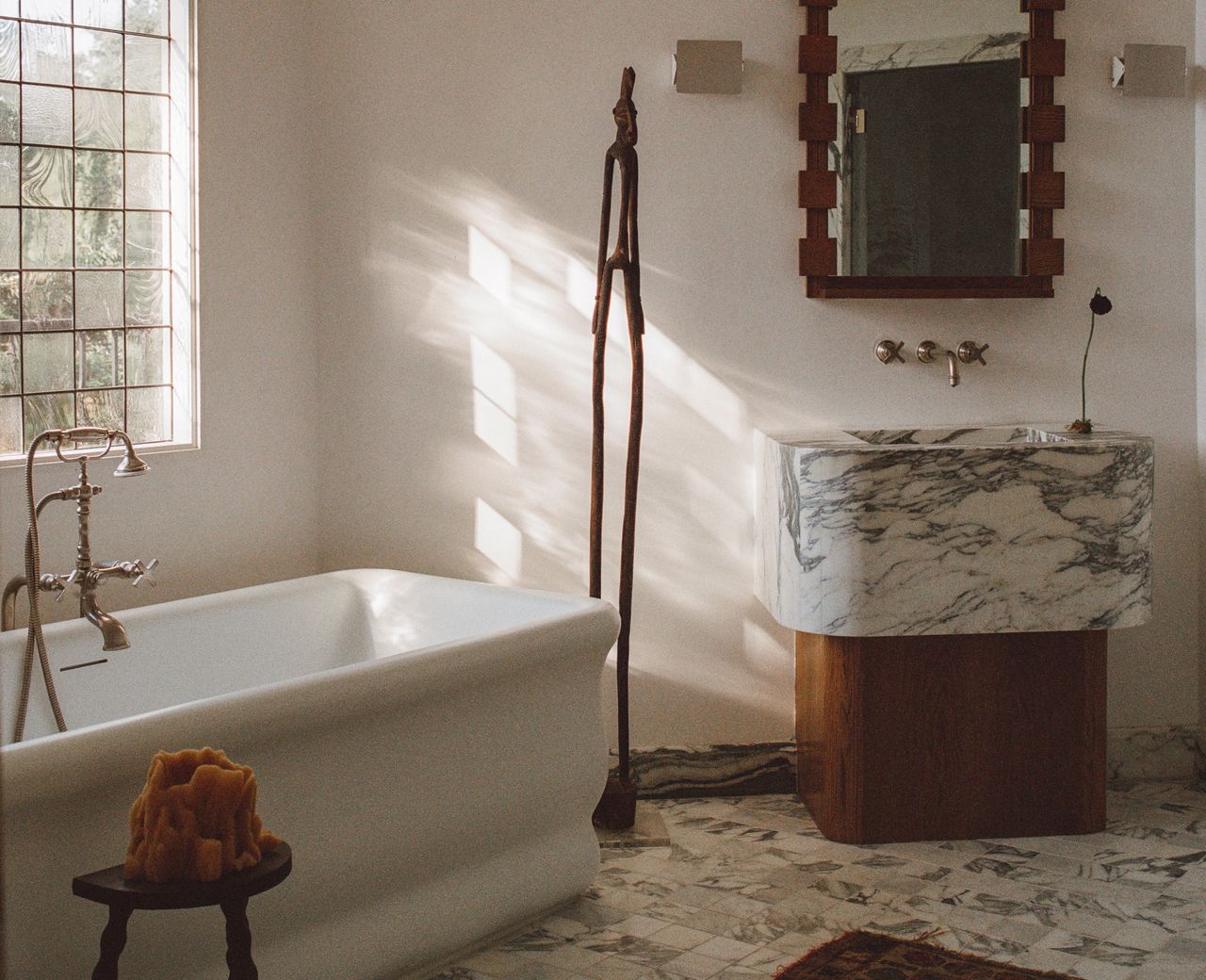 A bathroom with natural light and warm materials