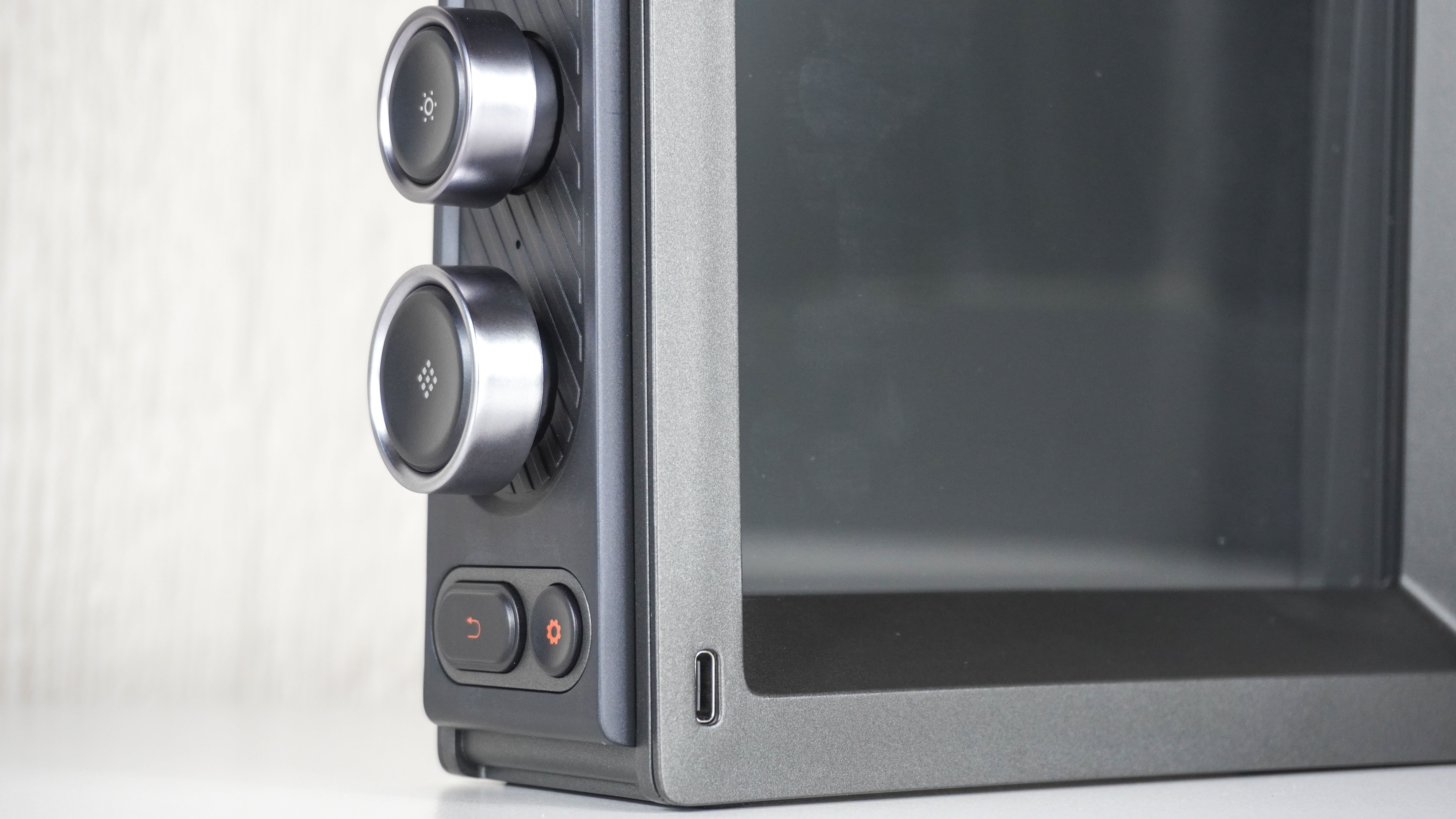 A close-up shot showing the knobs and buttons used to control the Divoom Times Frame and it's USB-C power port