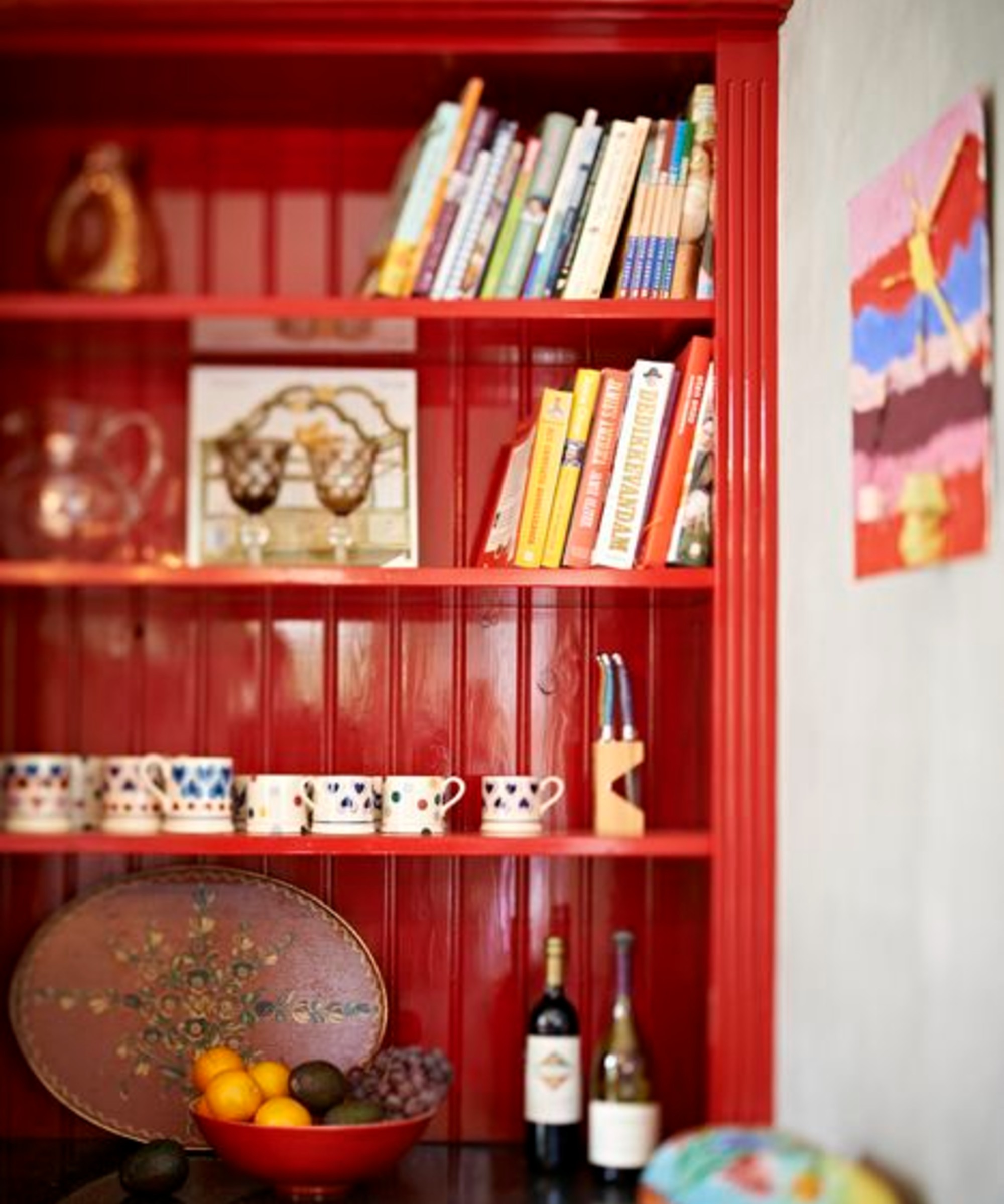 A pantry painted in a red Dulux paint with a glossy finish