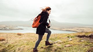 A young girl hiking alone in the wind 
