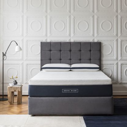 Brook + Wilde Ultima mattress on grey bed against white panelled wall