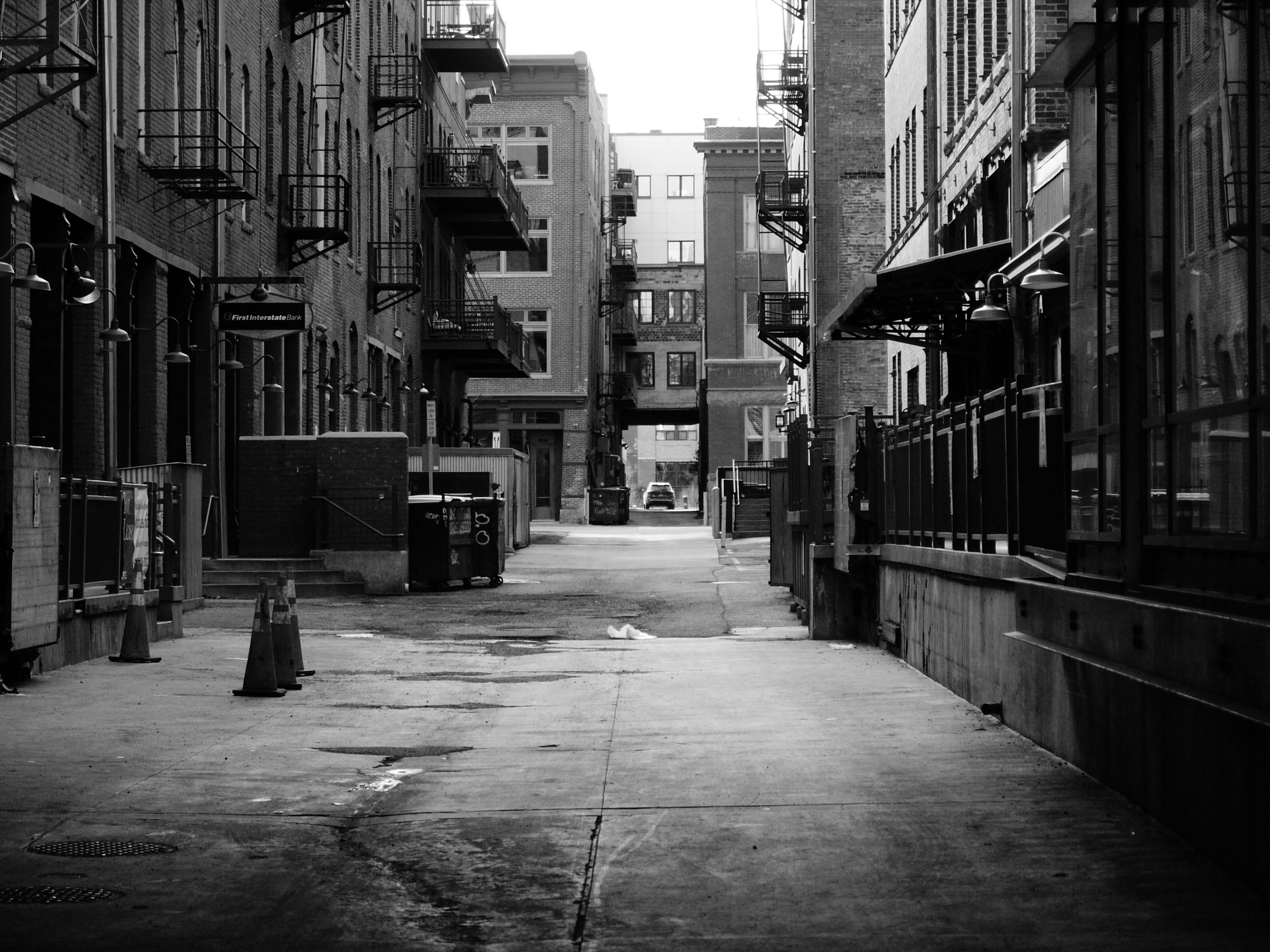A black and white street photo of a deserted alley, shot on the Lumix L1