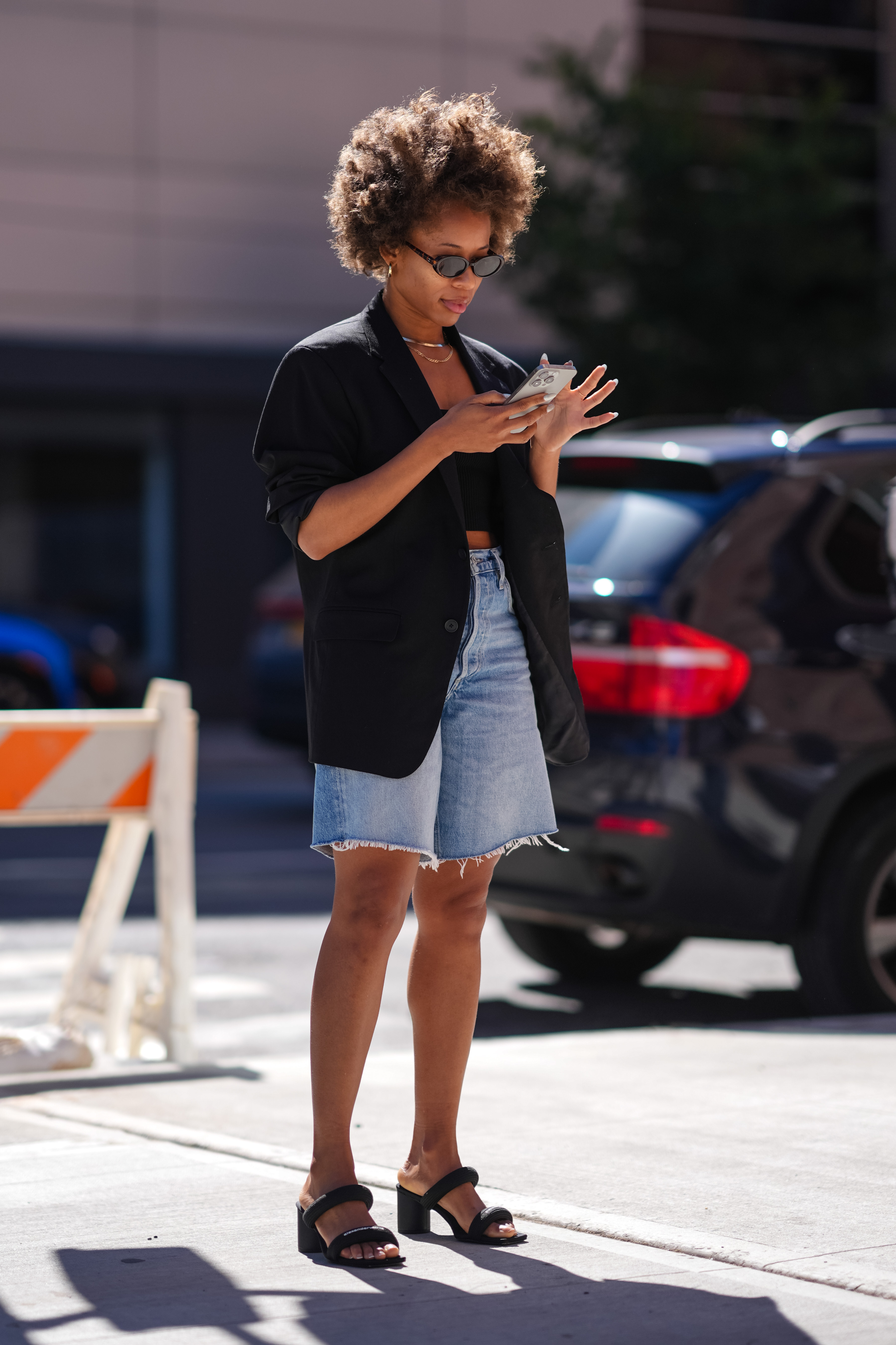 woman wearing denim shorts and a blzer