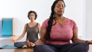 Woman relaxed and breathing, practicing face yoga at the end of a yoga session