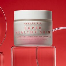 Super healthy skin anti-aging vitamin cream sold at Beauty Pie on a red background