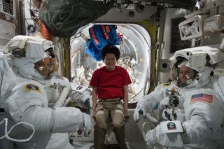 NASA astronauts Ricky Arnold (left) and Drew Feustel (right) try on their spacesuits on May 8, 2018, one week ahead of their spacewalk at the International Space Station. Norishige Kanai, an astronaut with the Japan Aerospace Exploration Agency, assisted them during the fitting and helped them out again when they were suiting up before heading out into the vacuum of space on May 16, 2018.