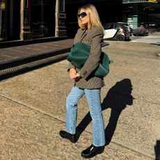 Morgan Stewart blazer jeans and loafer outfit with green the row margaux oversized clutch