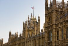 Westminster Parliament, home of the UK government, pictured during the day time with UK flag flying in background