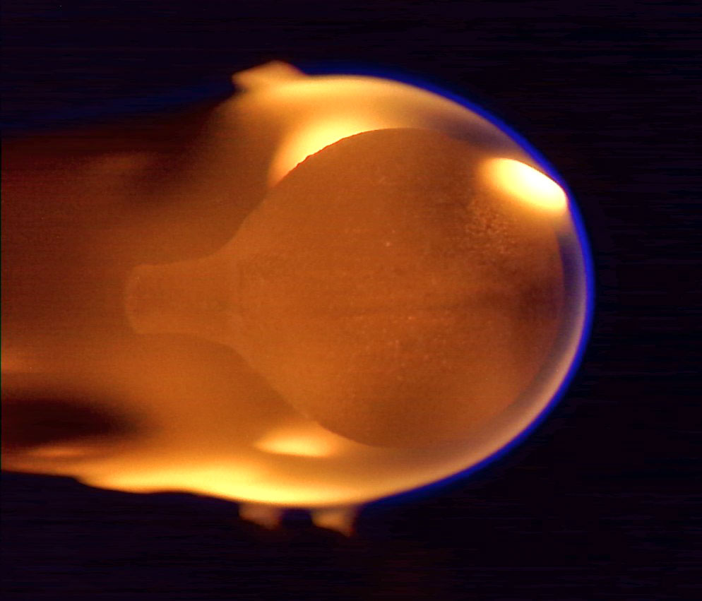 a ball of fire can be seen against a black background