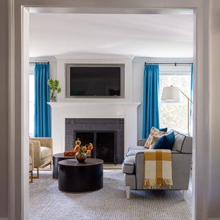 White living room with blue curtains