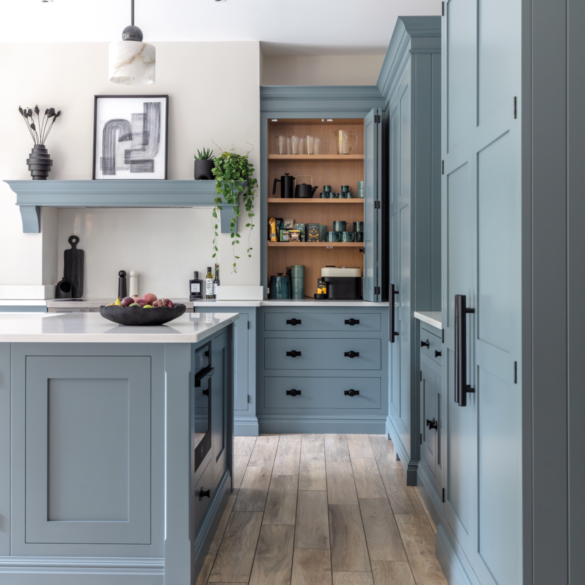 blue kitchen, globe lights, storage solutions, large kitchen island